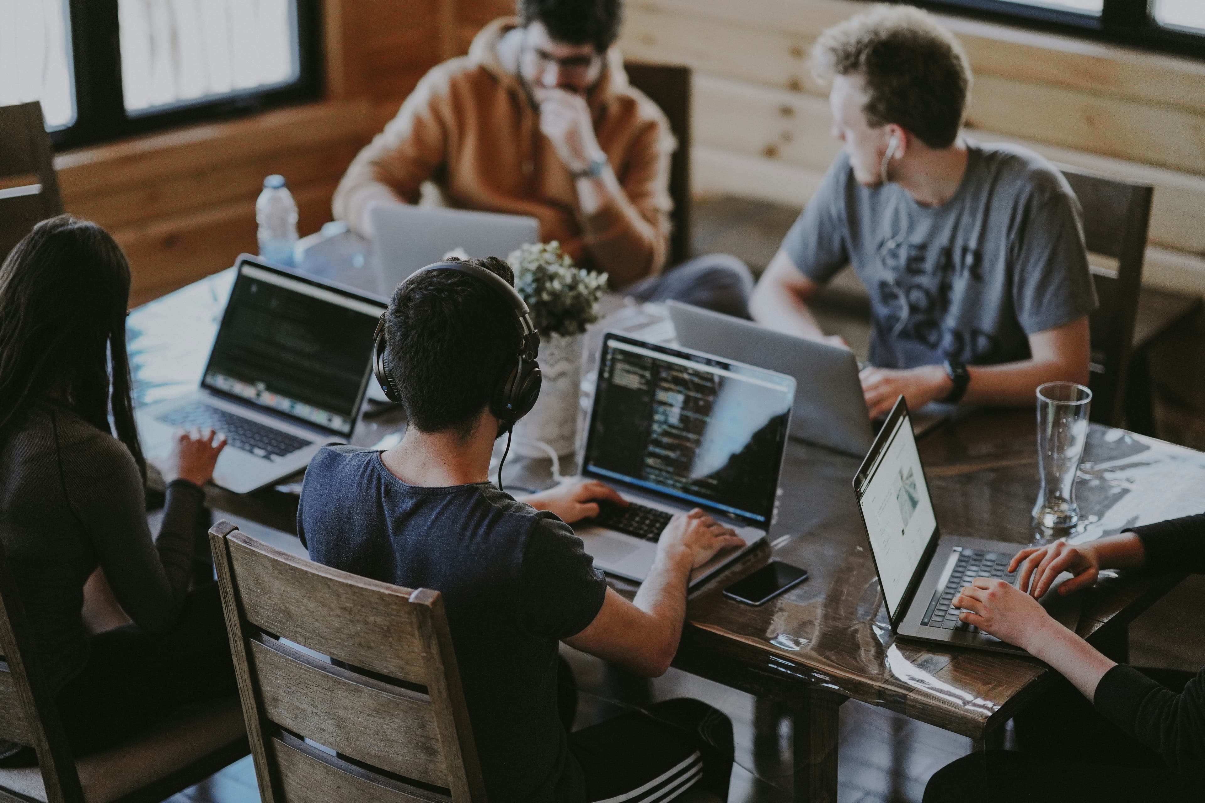Group of people using a laptop computer together